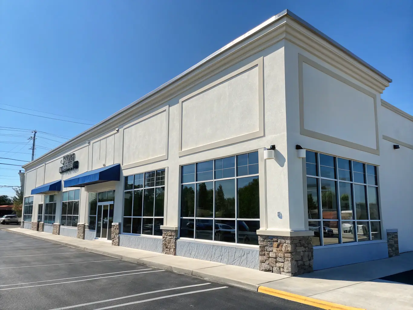 A commercial building with a spotless facade and clean surrounding pavement, highlighting our professional cleaning results.